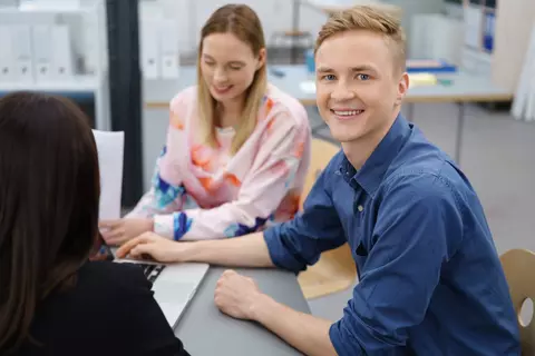 Ein junger Mann lächelt in die Kamera